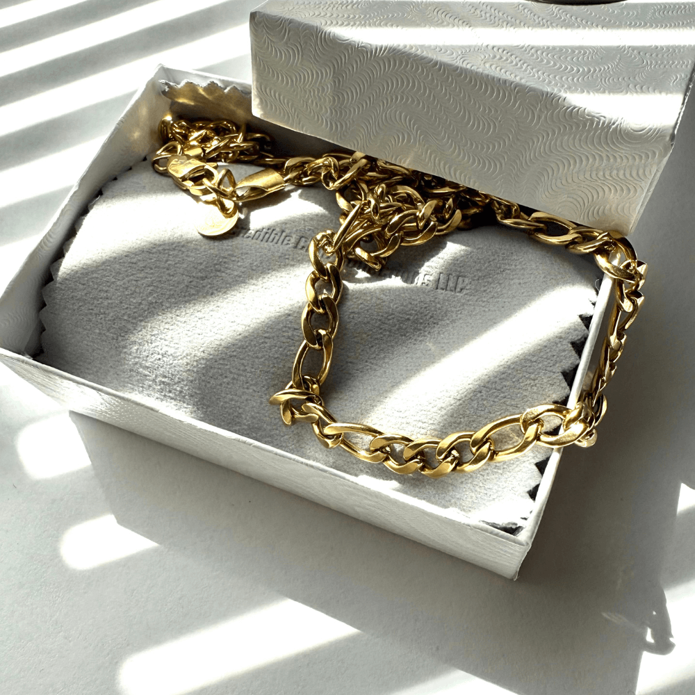 14k real gold filled Figaro chain necklace displayed in an elegant gift box with sunlit shadows.